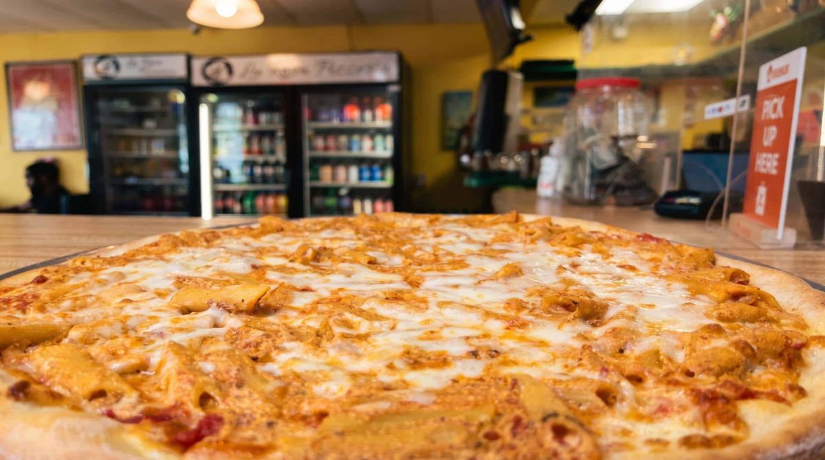 A baked ziti pie on the counter inside La Rosa Pizza