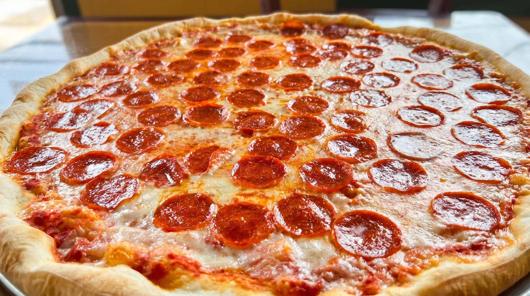 A whole pepperoni pie on the table at La Rosa Pizza