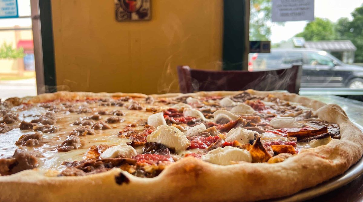 A specialty pie topped with sausage and ricotta at La Rosa Pizza